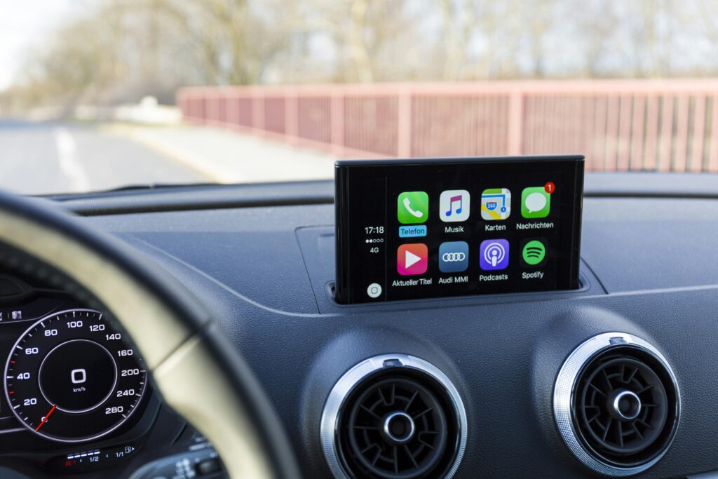 Photo of a luxury car's interior showcasing the digital navigation and audio display system.
